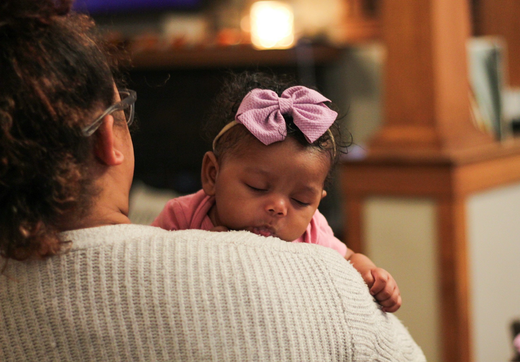 A teen mom holding a baby.