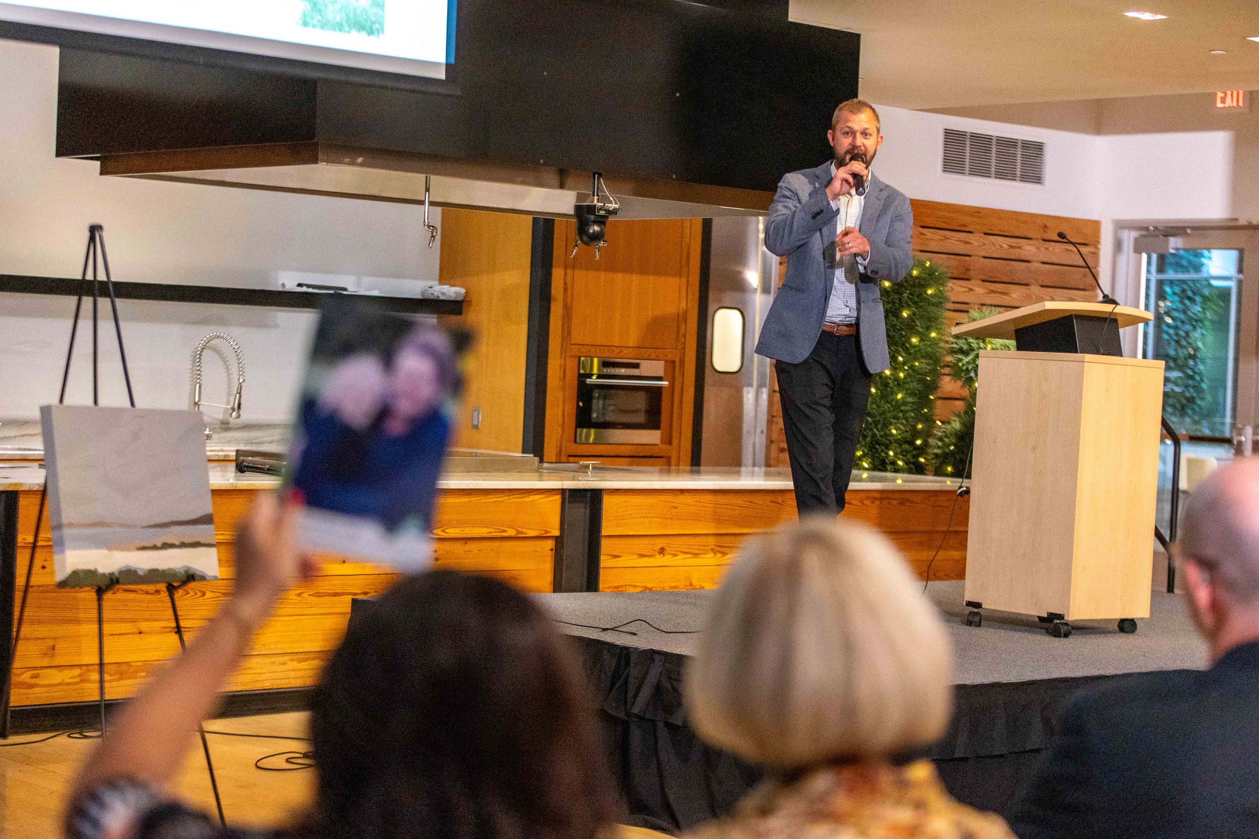 Kurt from Miedema Auctioneering presides over the live art auction at Growing in Grace: A Greenhouse Gala